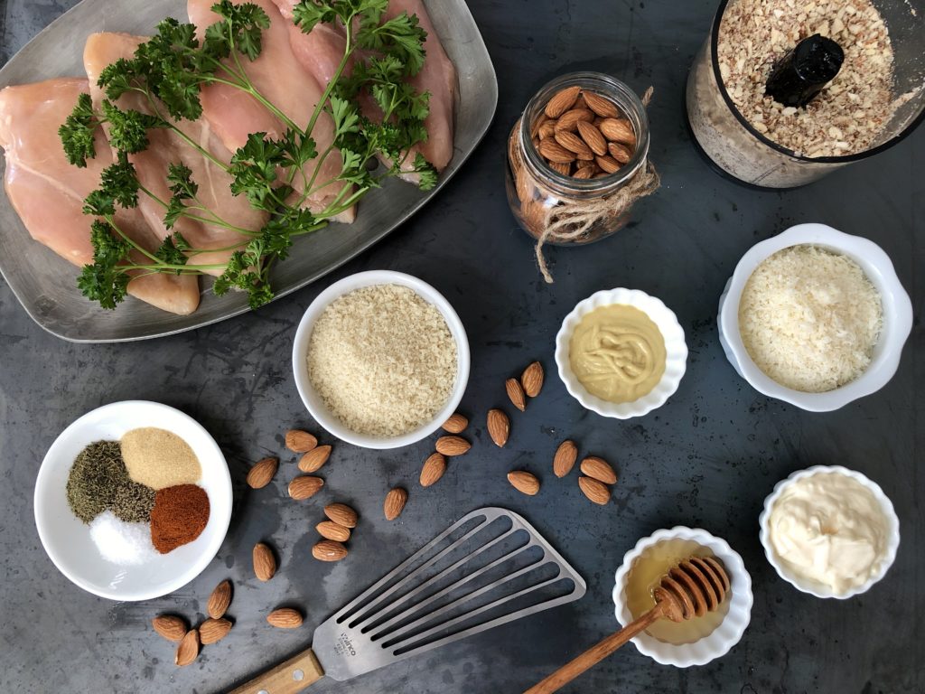 Chicken, almonds, seasonings, panko, parmesan, mustard, mayonnaise and honey.