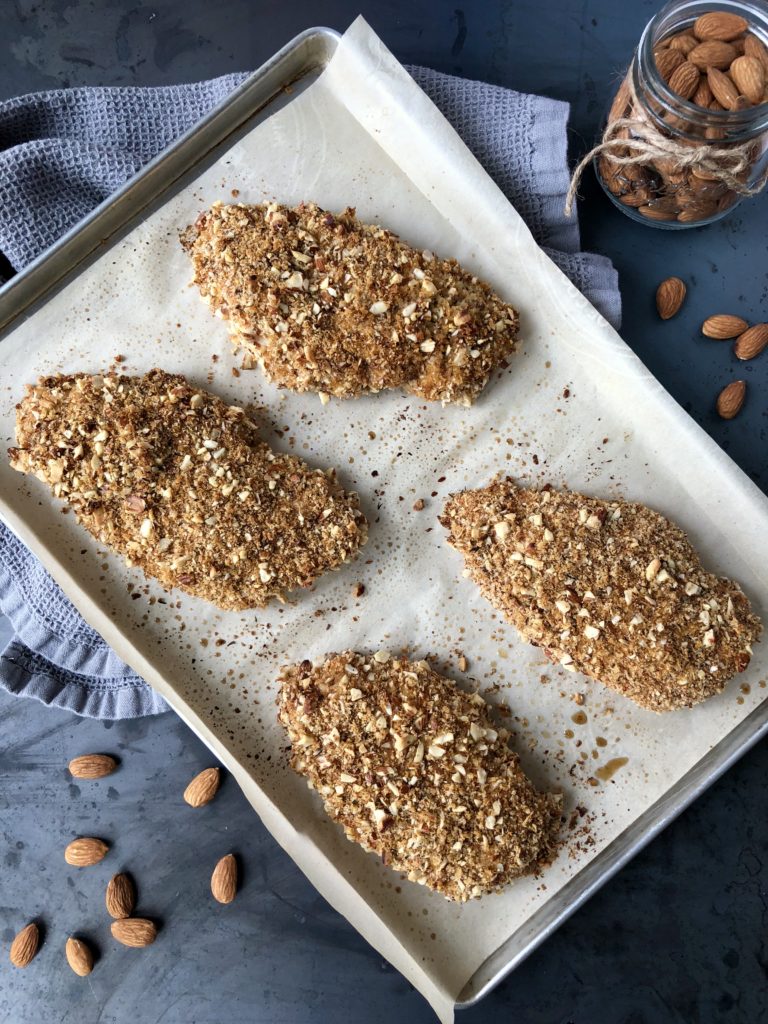  Crispy baked chicken on a baking sheet out of the oven.