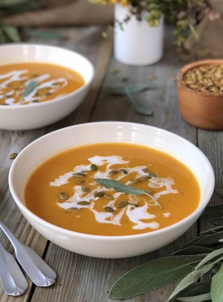 Soup in white bowl with sage leaf