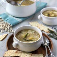 Two bowls of soup with crackers