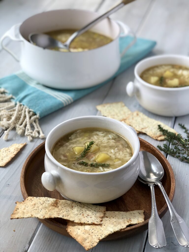 Two bowls of soup with crackers