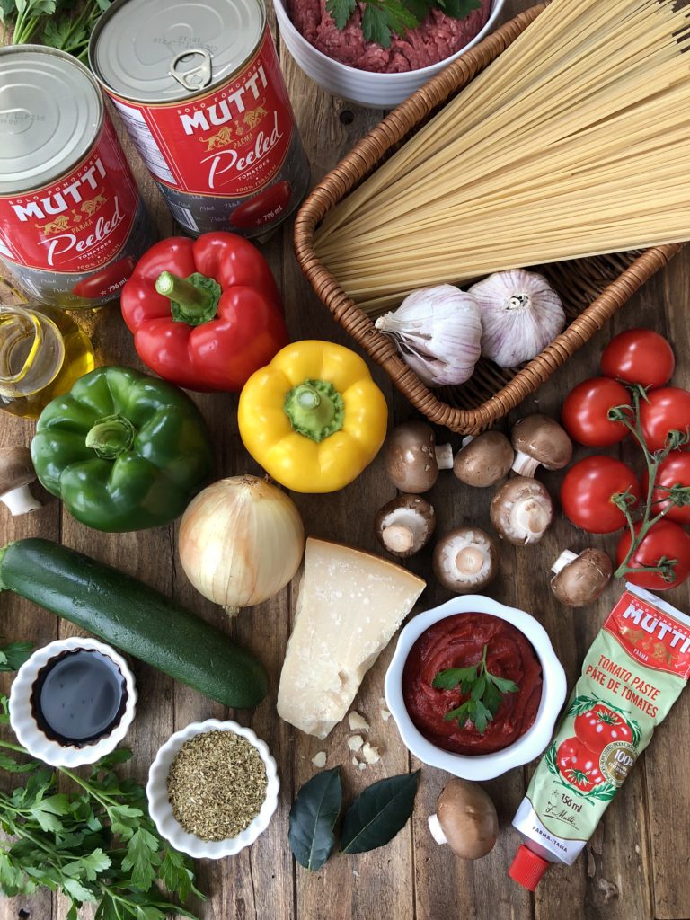 Fresh peppers, canned tomato jars, spaghetti and other ingredients