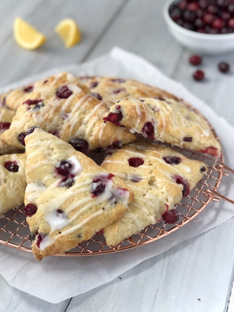 Close view of glazed scones piled on a gold rack