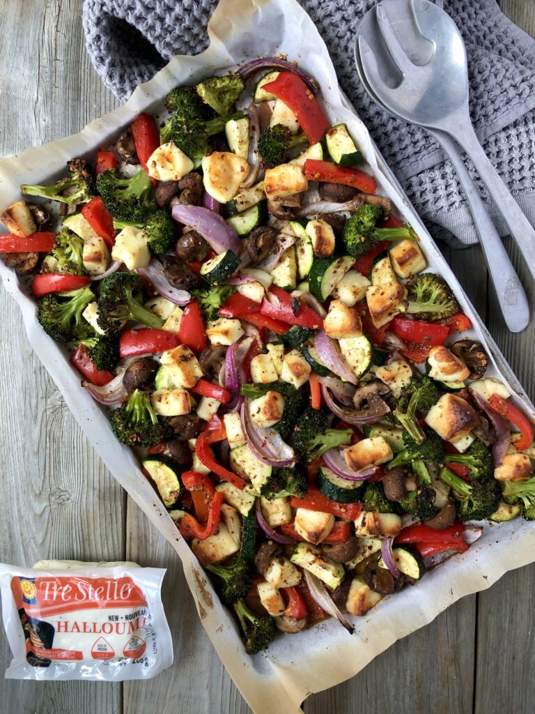 Roasted harissa veggies on a tray with Tre Stelle halloumi.