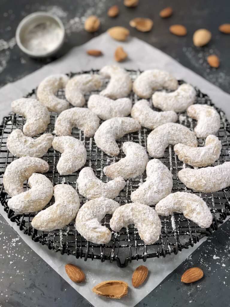 Crescent shaped cookies dusted with icing sugar