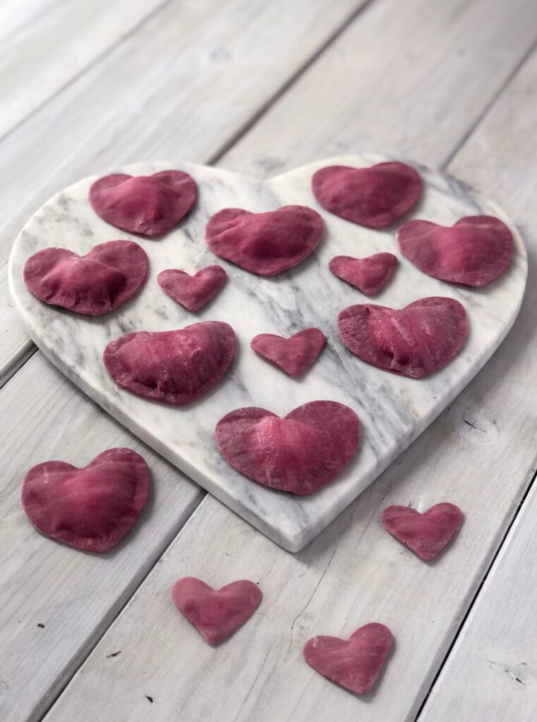Heart shaped ravioli on a marble heart tray