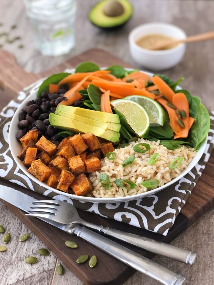 Bowl with sweet potatoes, rice, carrots and spinach