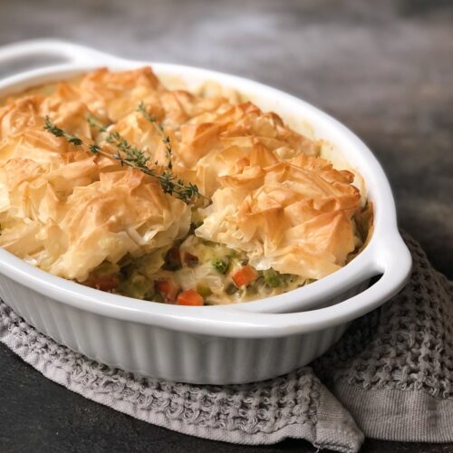 Phyllo topped chicken pot pie in casserole dish.