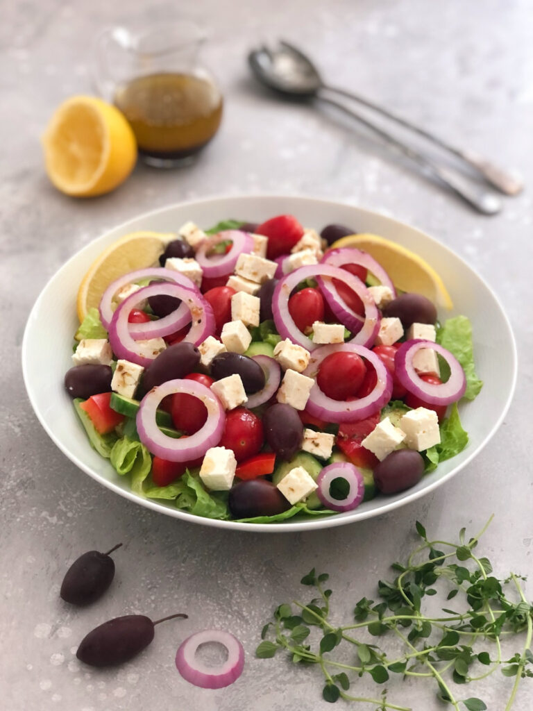 Greek salad with red onions, olives and feta