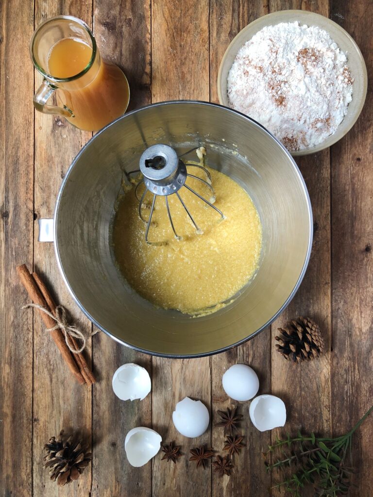 Butter, sugar, eggs in a mixing bowl.