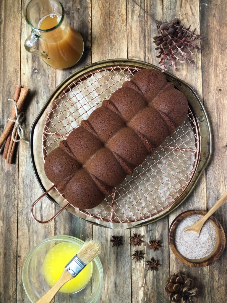 Plain donut cake on cooling rack.