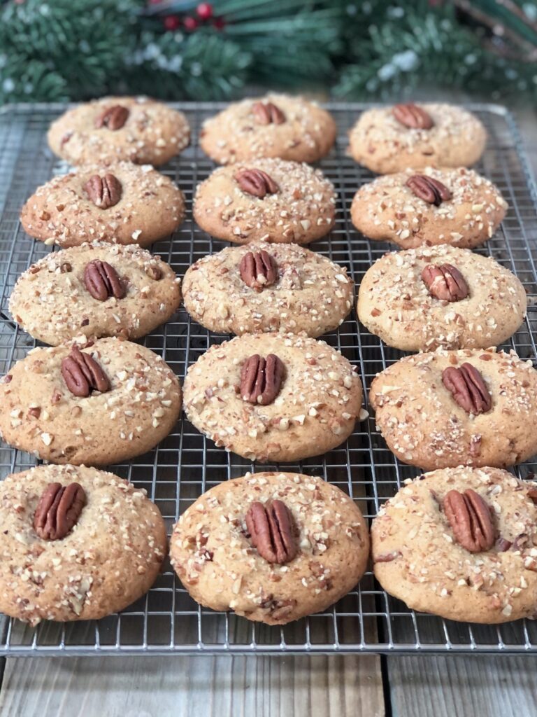 Pecan cookies lined up on a metal rack