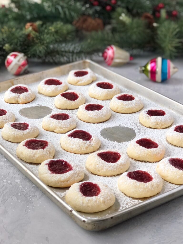 Jam thumbprint cookies dusted with icing sugar