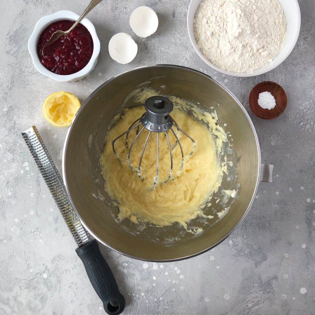 Eggs added to butter sugar mixture in bowl