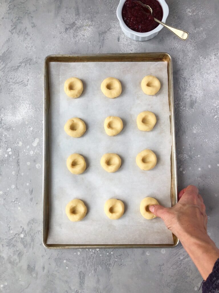 Thumb making indentation in cookie dough