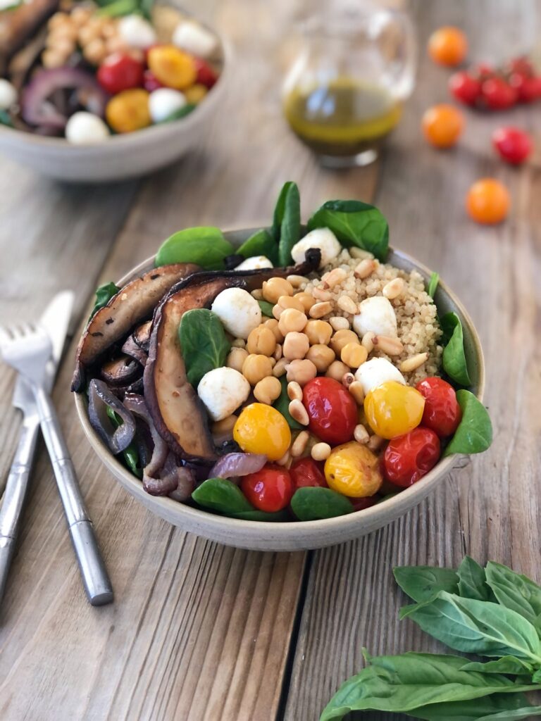 Mushroom Quinoa Salad Bowls with cutlery beside one bow.