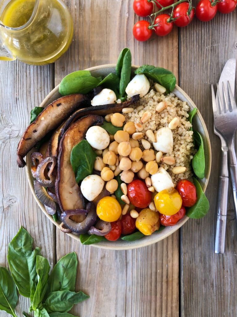 Top down view of assembled quinoa and chickpea salad with cutlery beside.