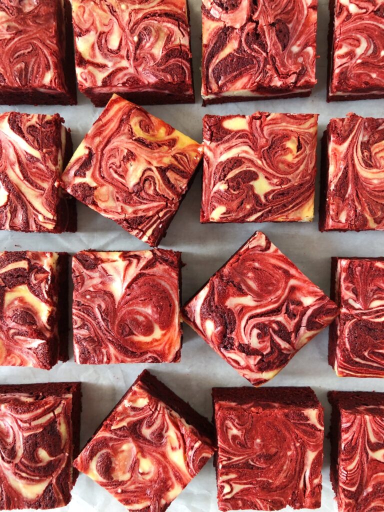 Top view, close-up of red velvet brownies lined up on parchment paper.