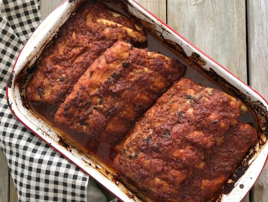 Roasted and caramelized oven baked ribs in a baking pan
