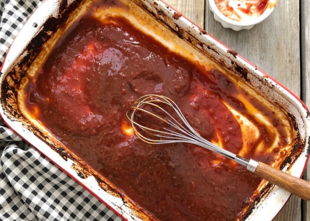Barbecue sauce being whisked in the baking pan