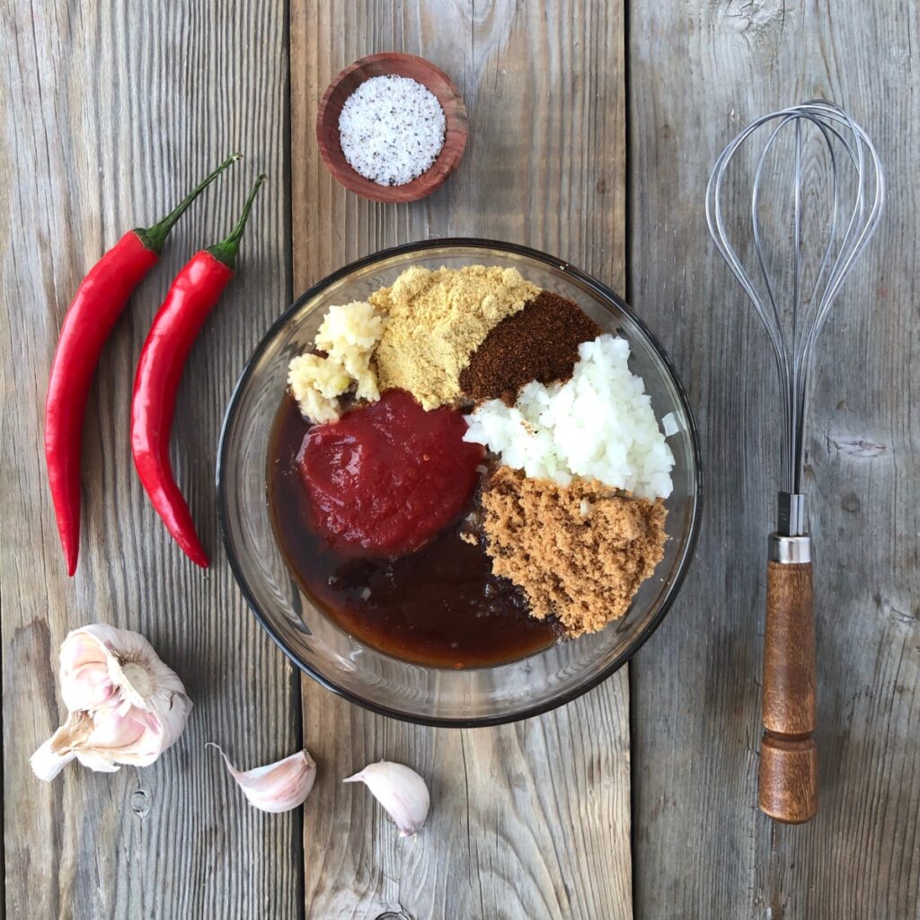 Chili sauce, sugar, vinegar, Worcestershire sauce and seasonings in a bowl