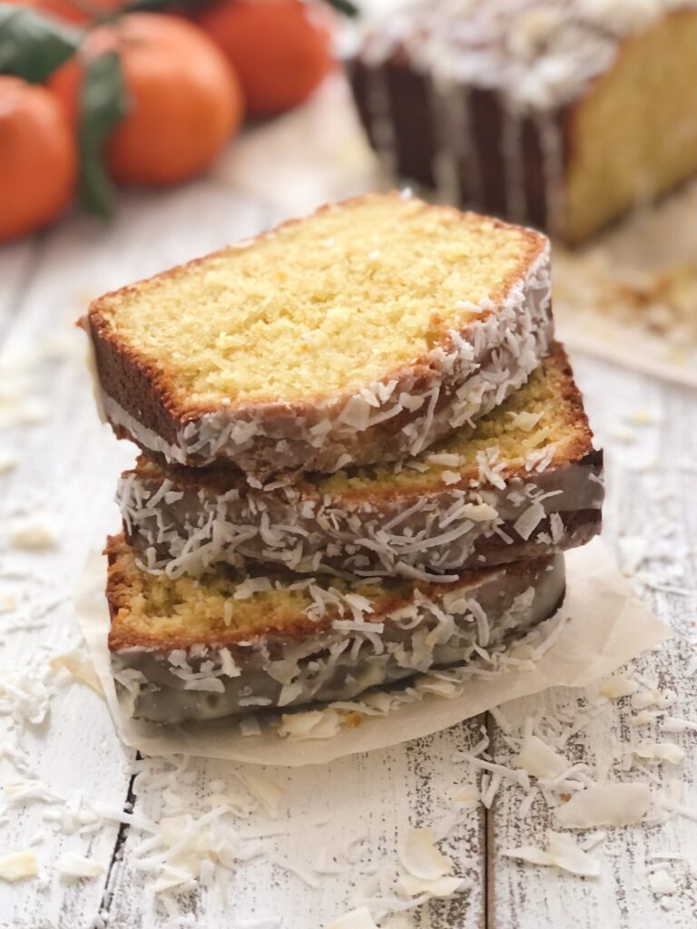 Three pieces of moist orange loaf stacked.