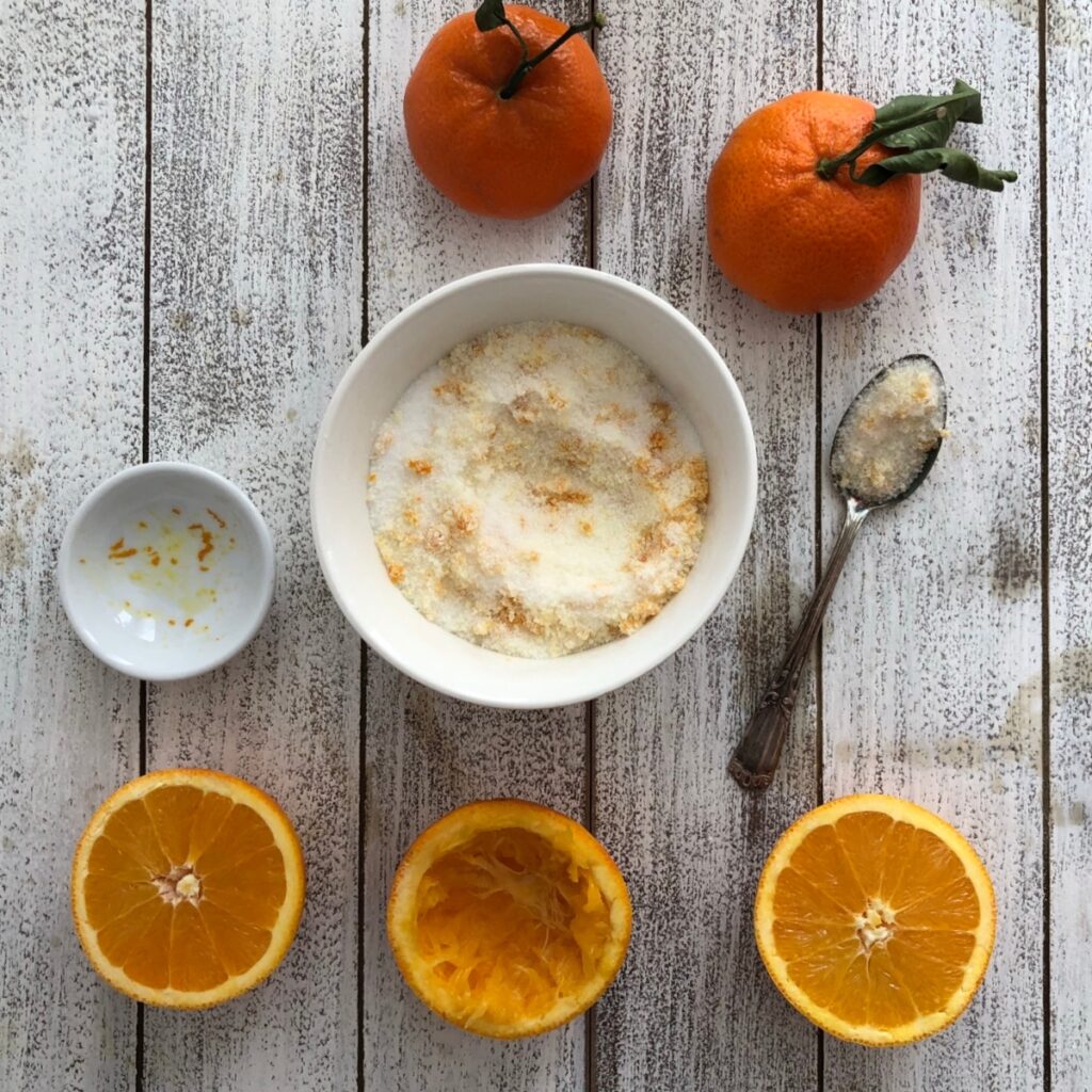 Bowl of sugar being infused with orange zest.