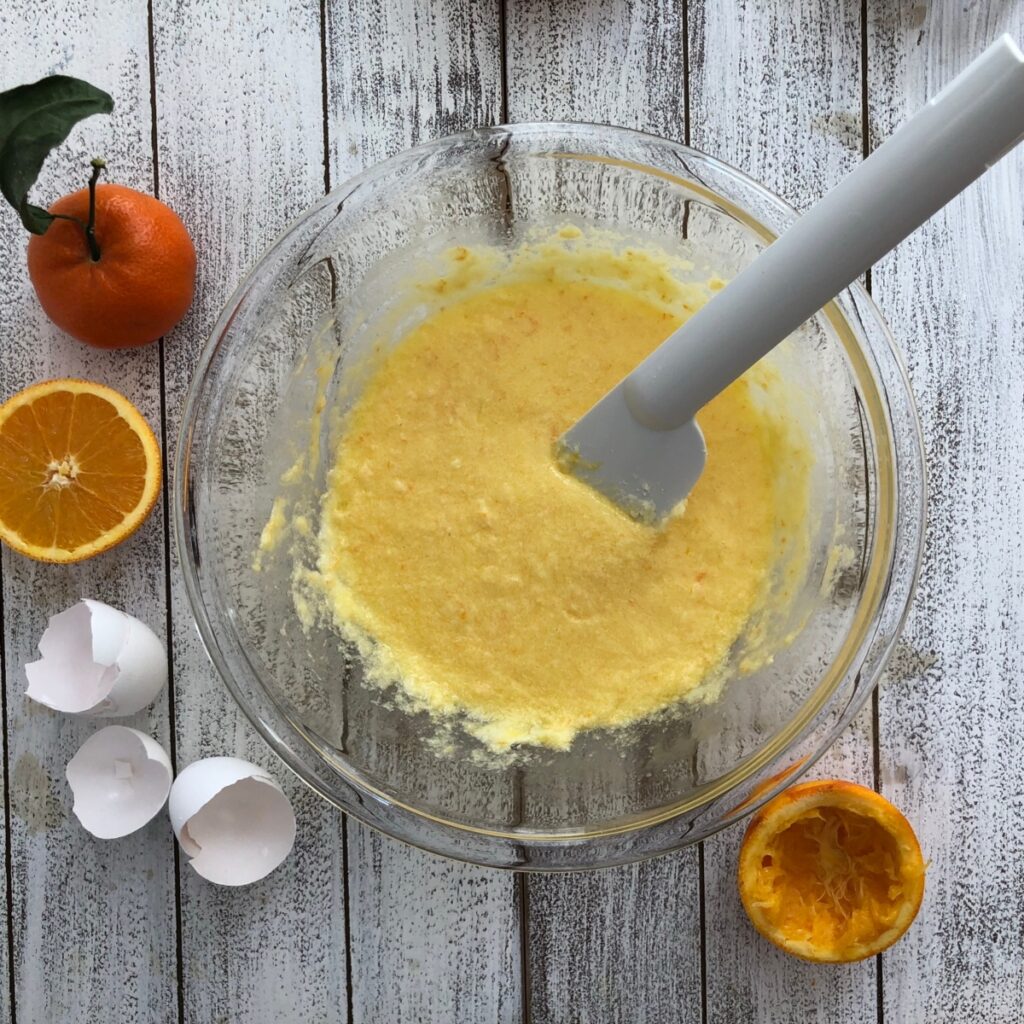 Eggs and orange juice beaten into the butter and sugar mixture.
