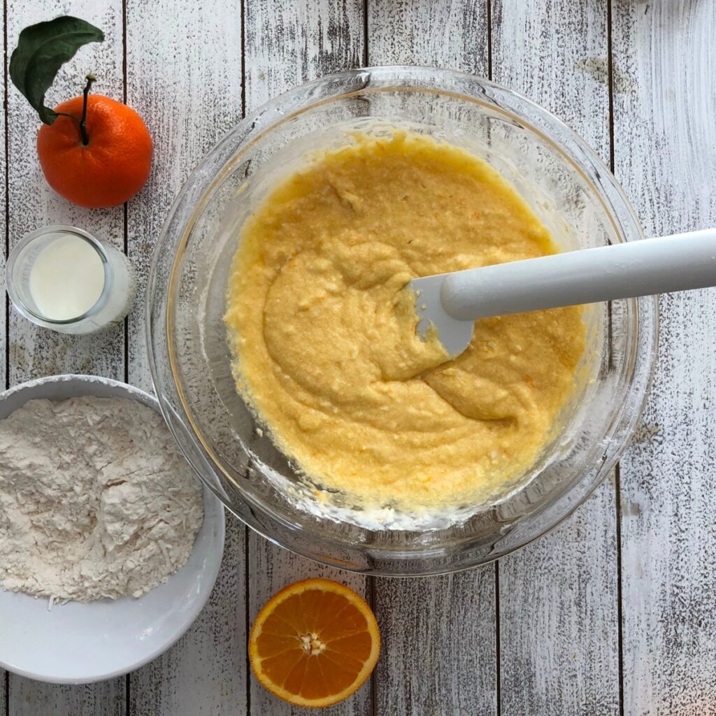 Dry ingredients gradually being folded into wet ingredients.