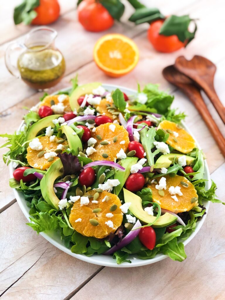 Goat cheese salad arranged on a platter with garnishes.