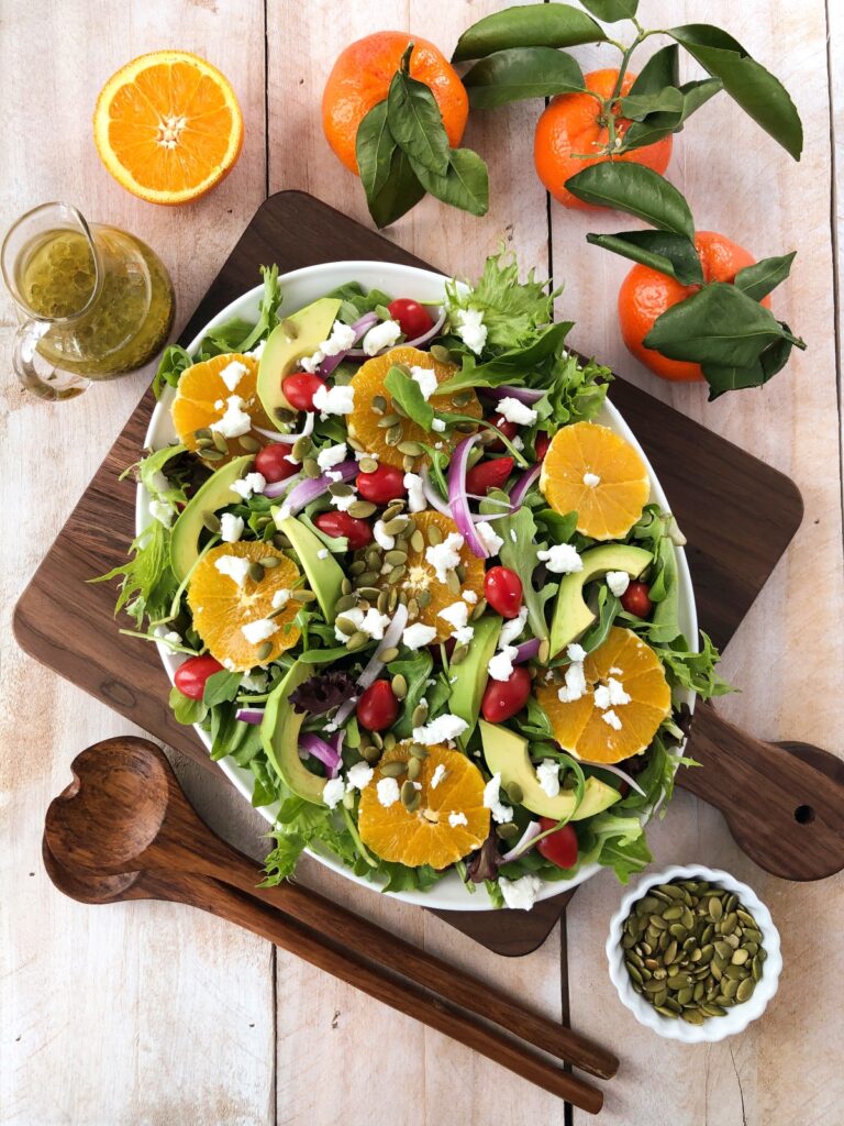 Orange salad ready to be drizzled with orange vinaigrette.