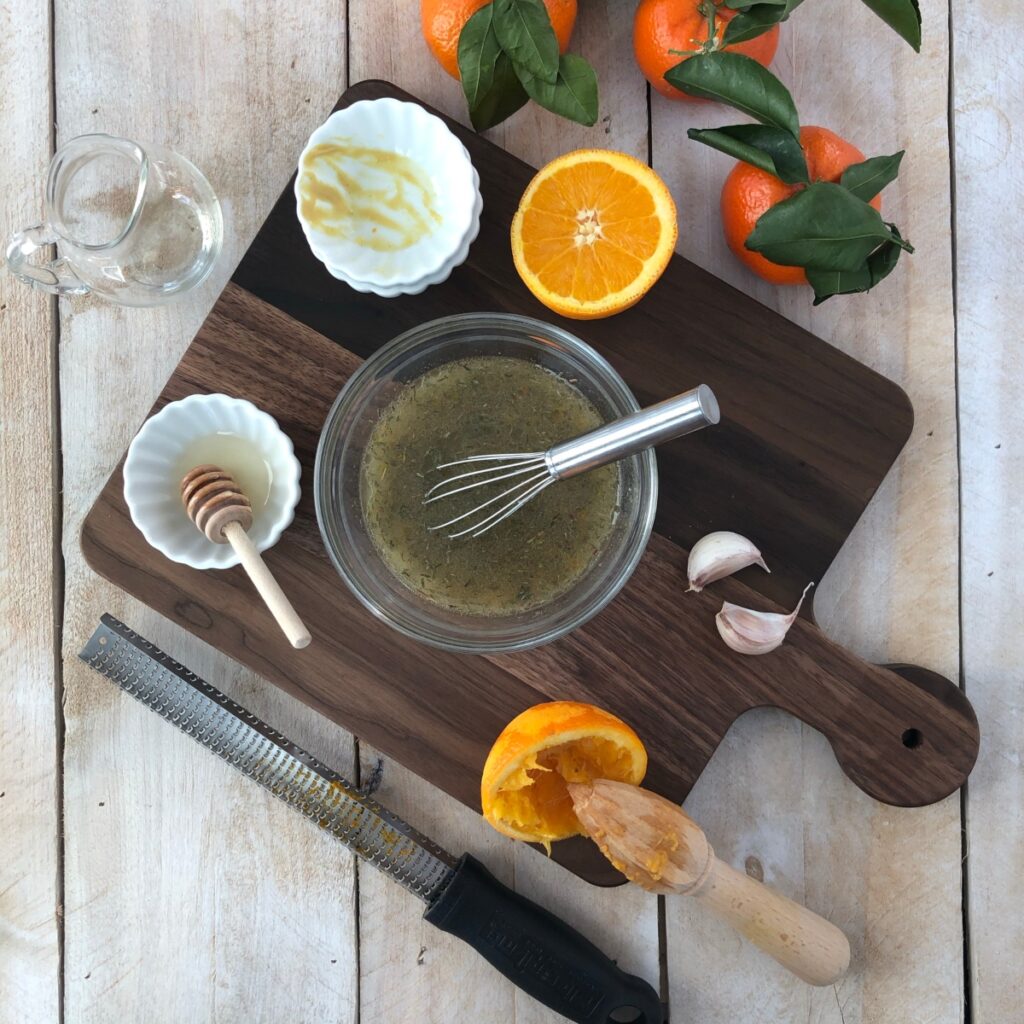 Orange Vinaigrette ingredients being whisked together.