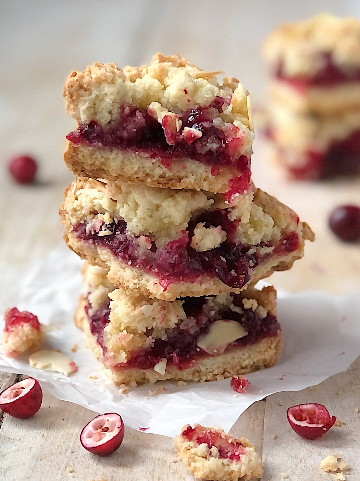 Cranberry bars stacked with cranberries spewing out.