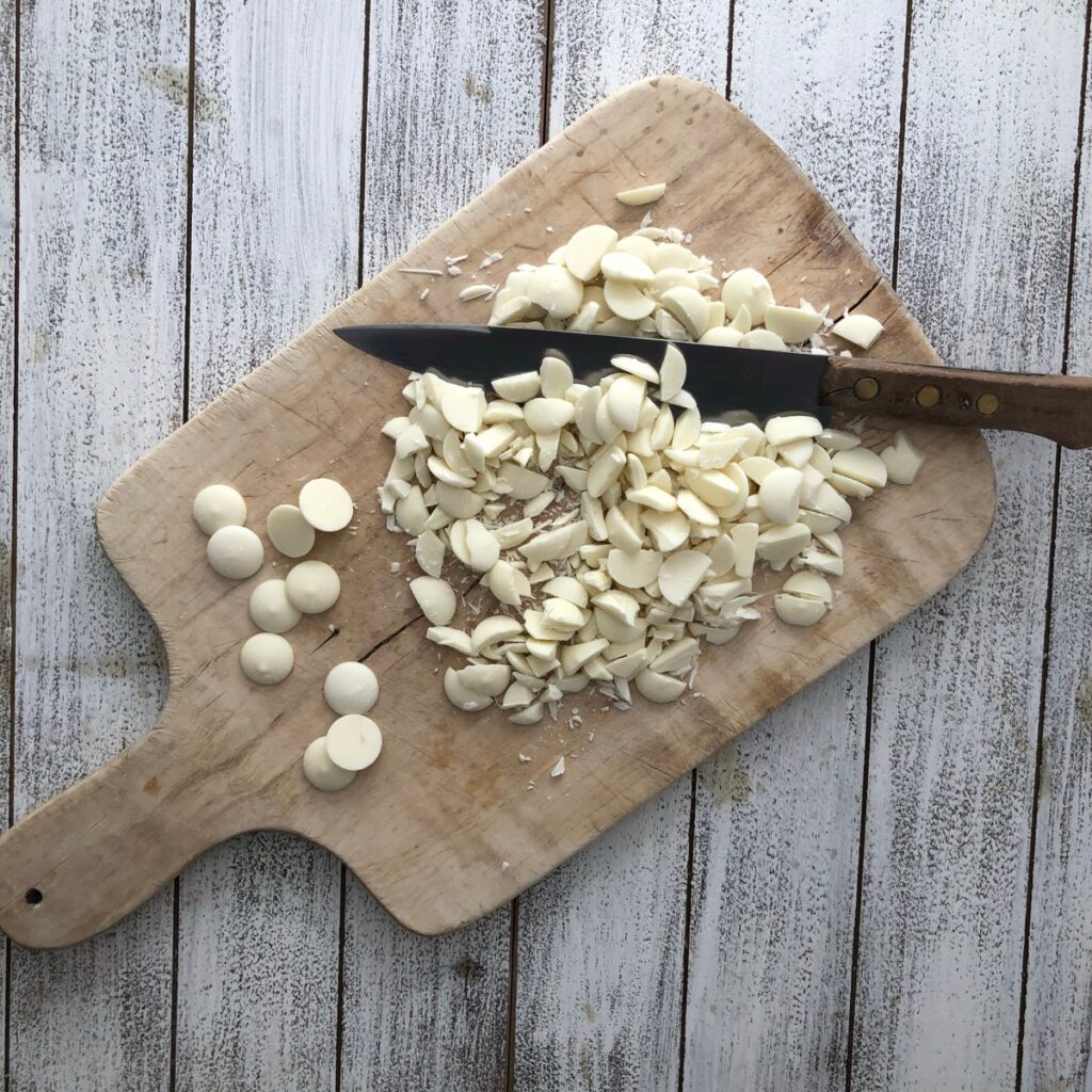 Chopped white chocolate on a wood board