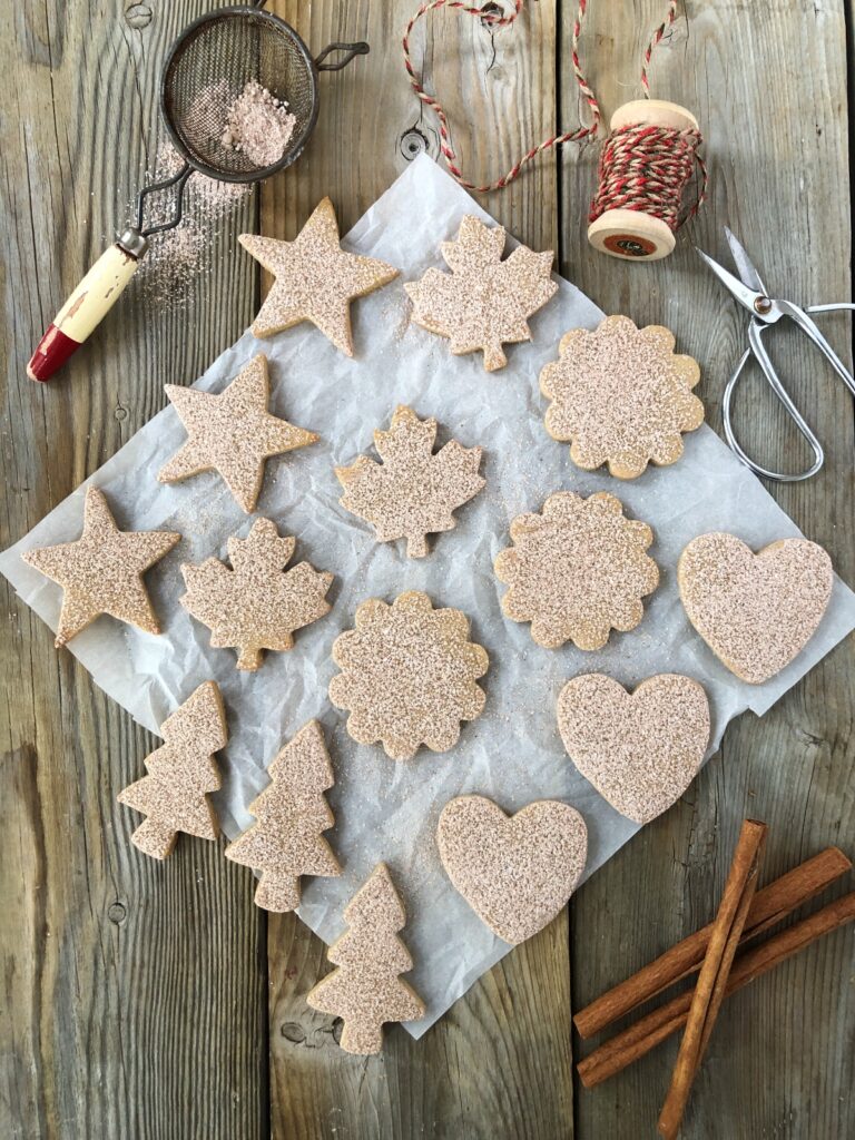 Baked cinnamon cookies cut out in assorted shapes