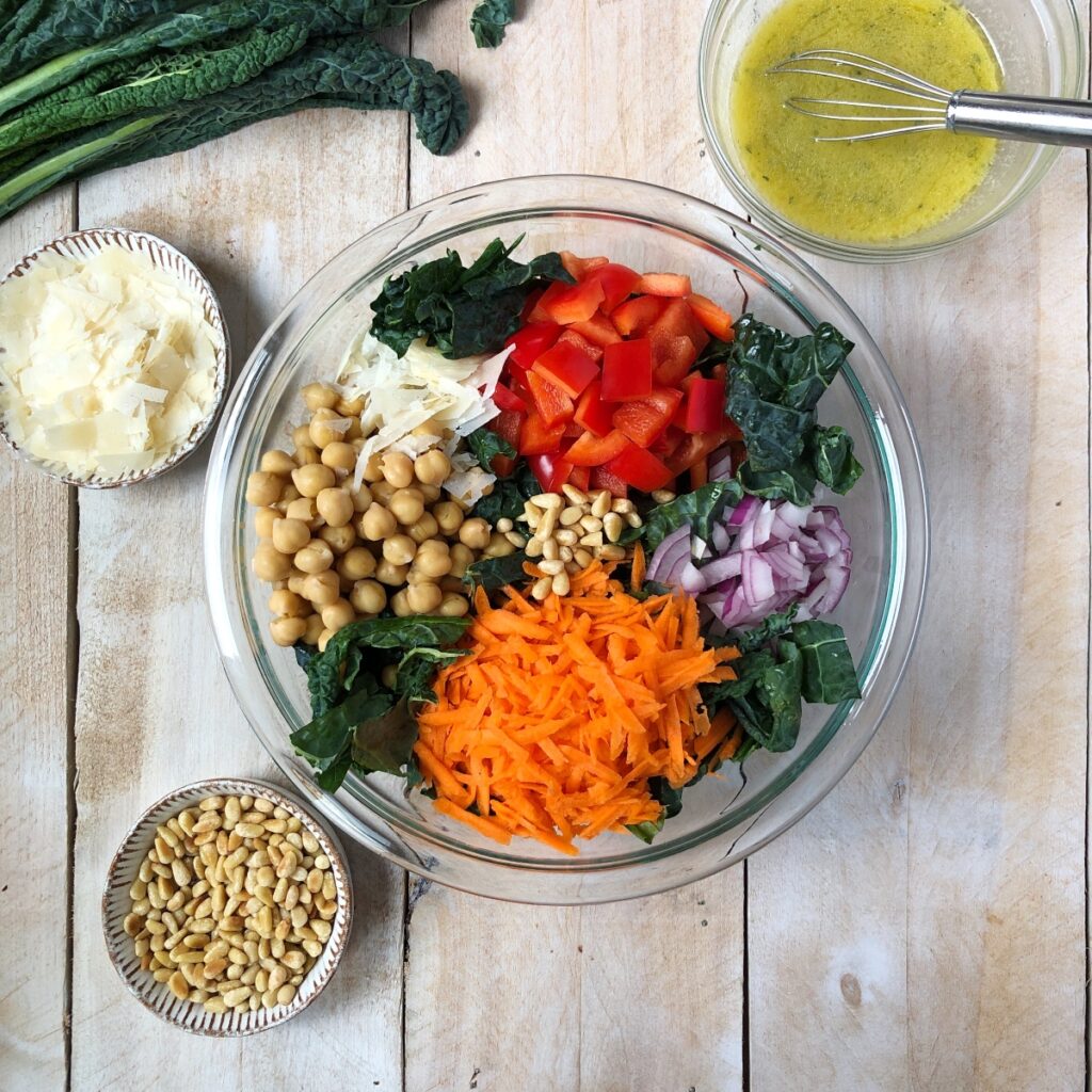 All salad ingredients added to a large bowl.