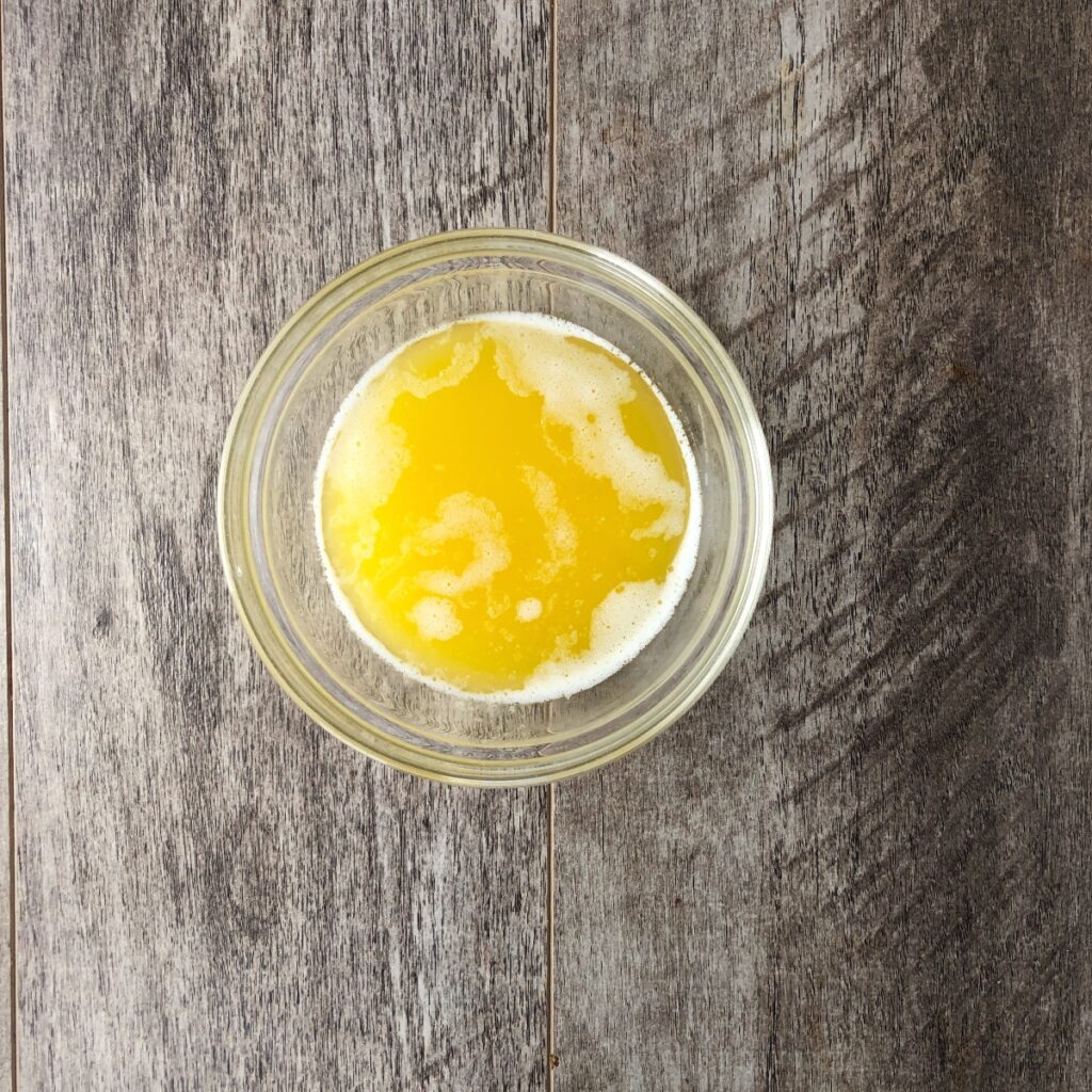 Glass bowl of melted butter.