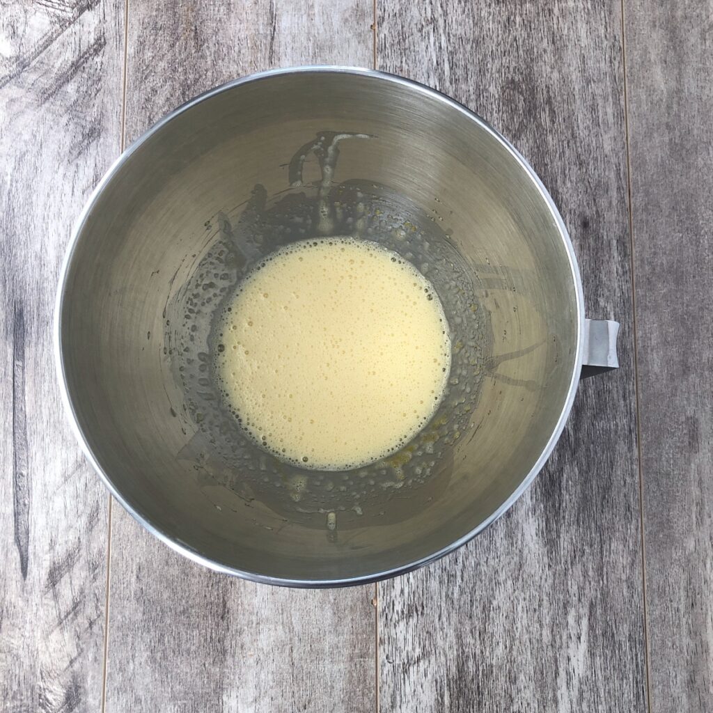 Mixing bowl with eggs and sugar beaten until bubbly.