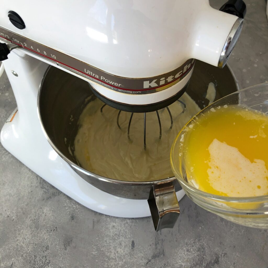 Melted butter being poured into batter.