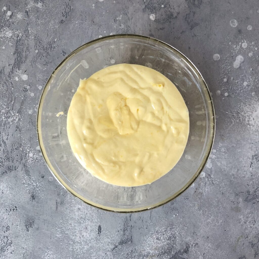 Mixed Madeleine batter in a glass bowl.