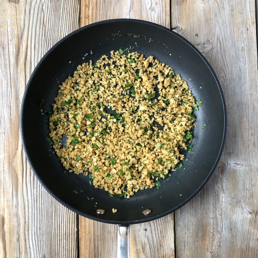 Skillet with toasted parmesan breadcrumb topping.