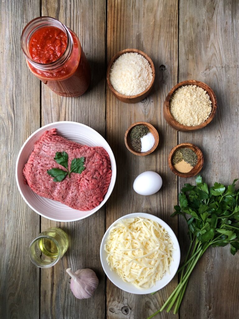 Tomato sauce, parmesan, breadcrumbs, beef, seasonings, egg and mozzarella.