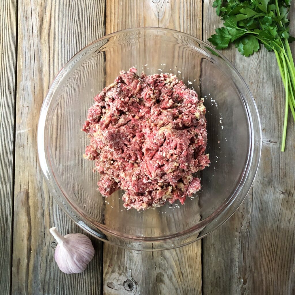 Meatball ingredients mixed together in a bowl.