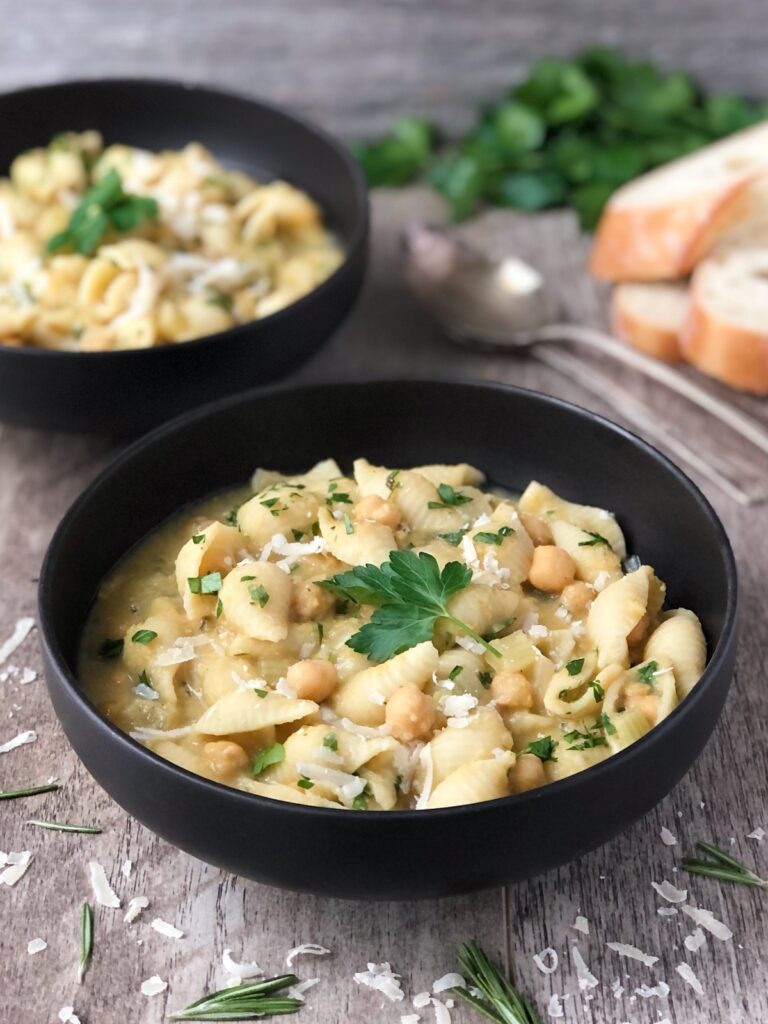 Two bowls filled with pasta e ceci.