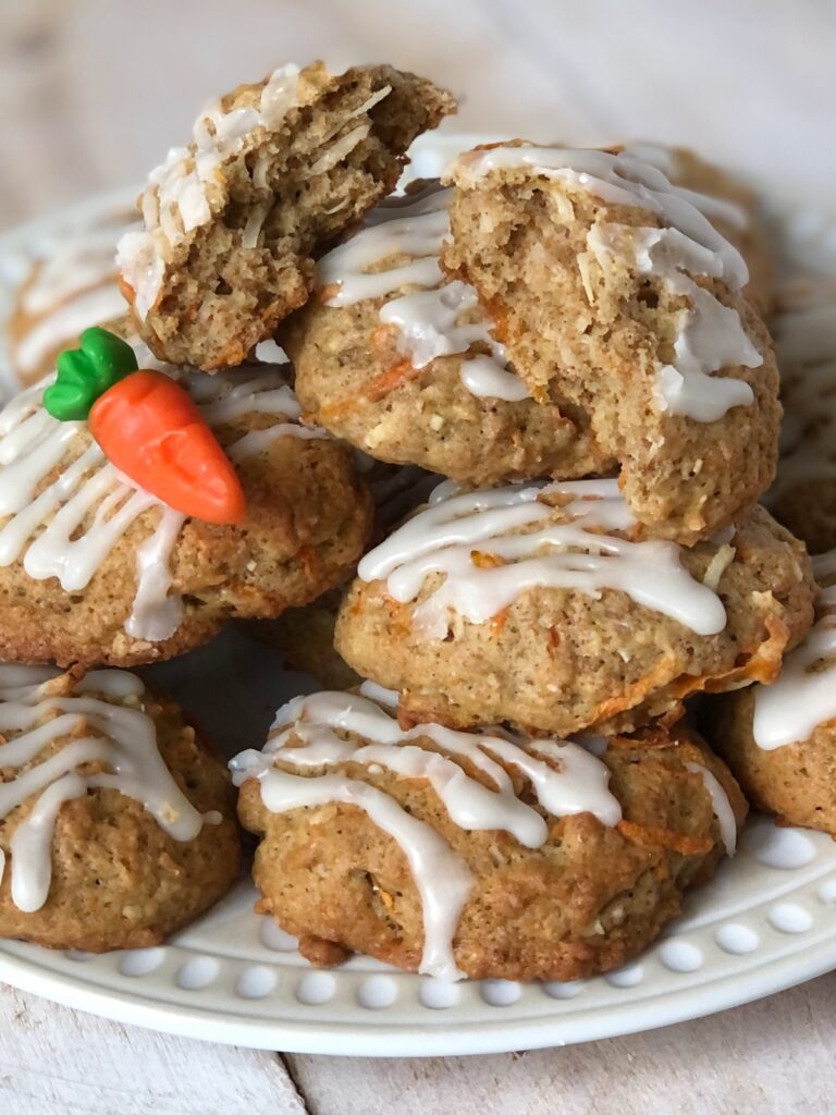 Carrot cake cookies on a plate with one cracked open.