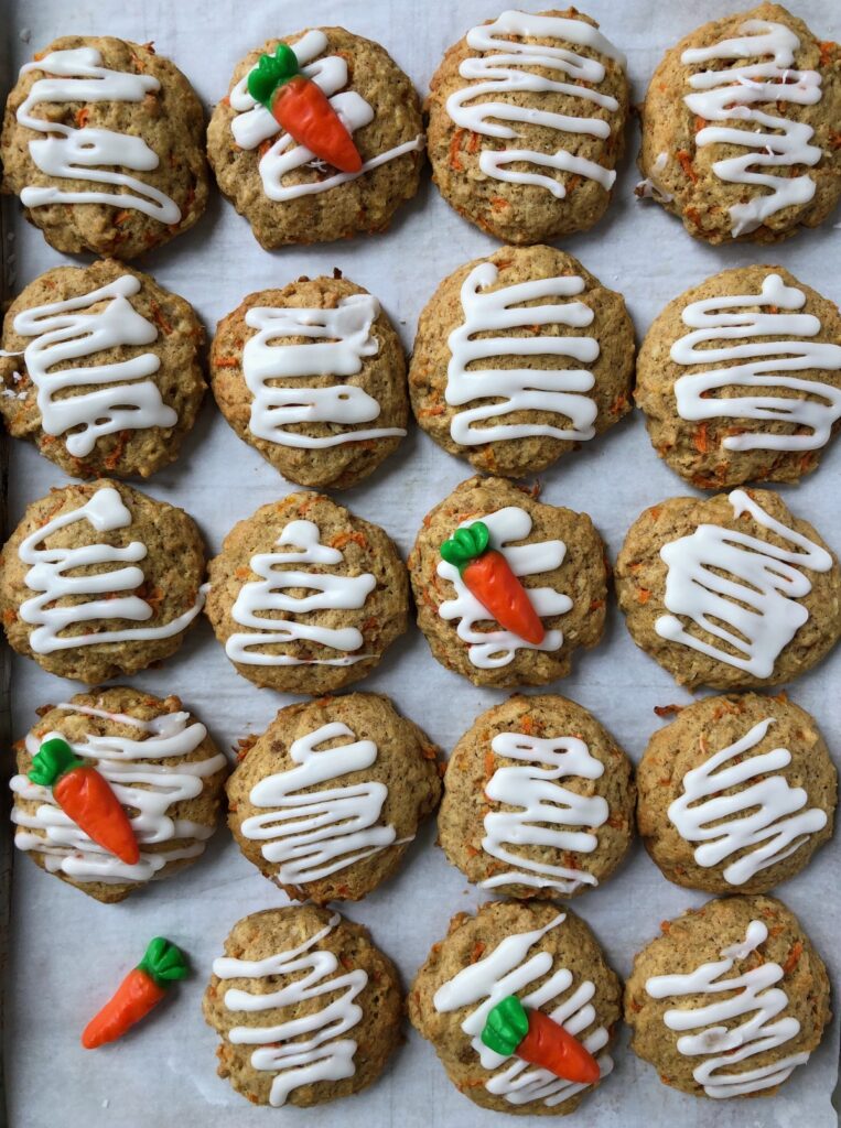 Top down view of carrot cake cookies and carrot candy decoration.
