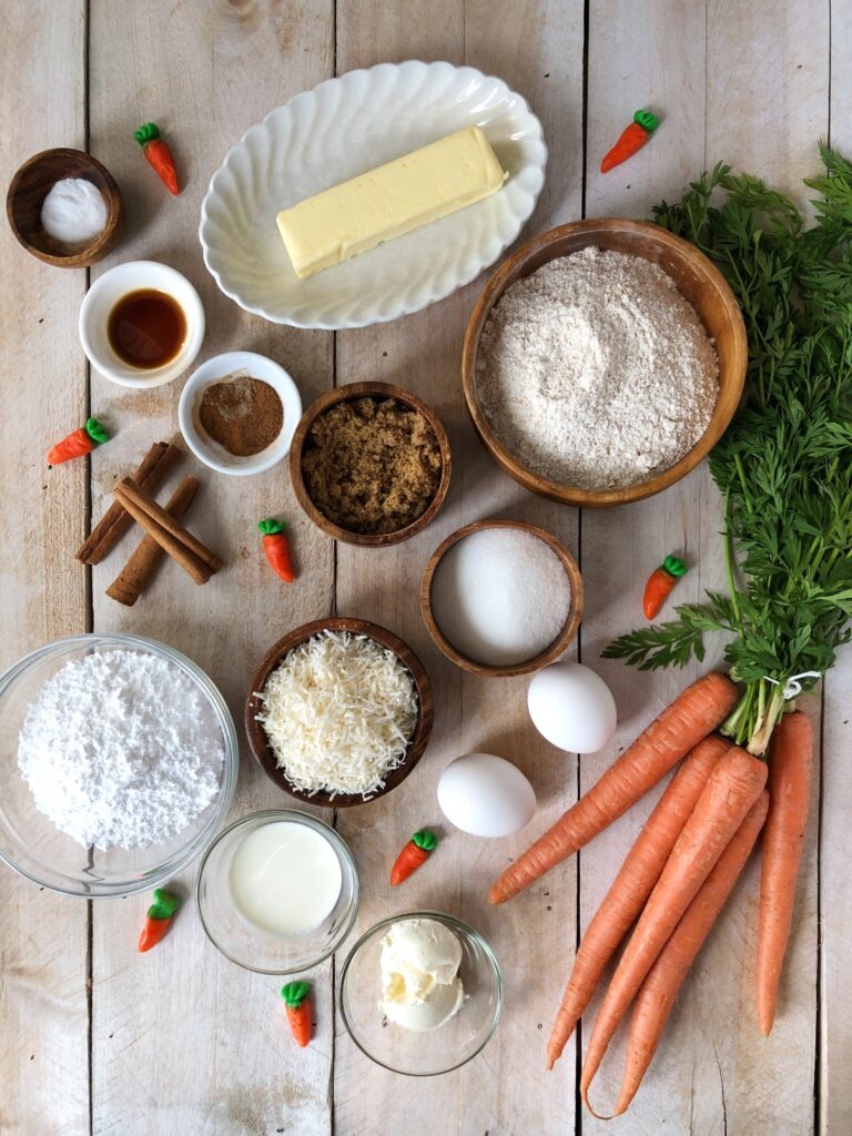 Butter, spices, flour, sugar, coconut, eggs, carrots, icing sugar, cream cheese.