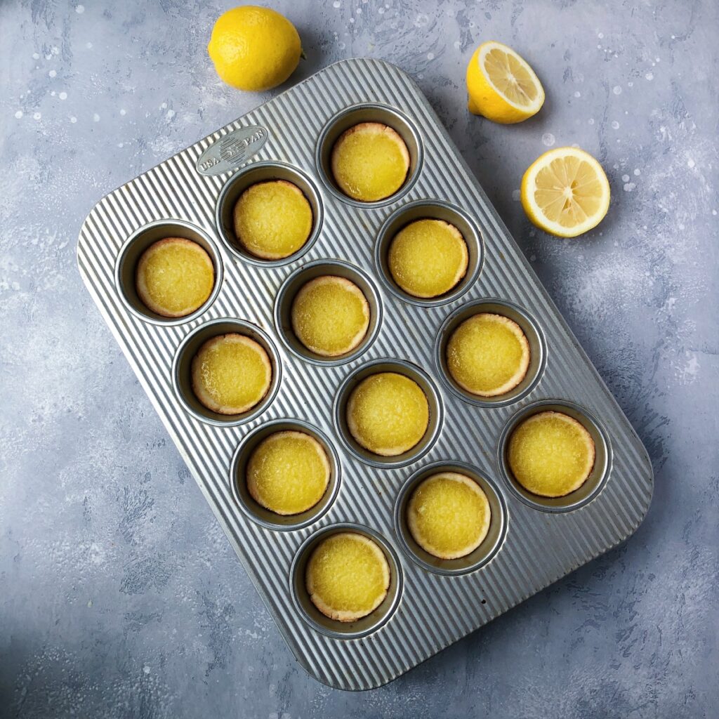 Baked lemon tarts out of the oven.